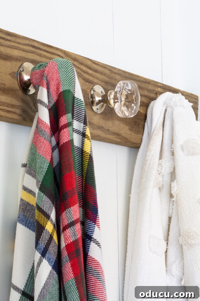 Elegant Wall Organizer for Living Room Throws 2 blanket display ideas - wood holder on wall using doorknobs as hooks.