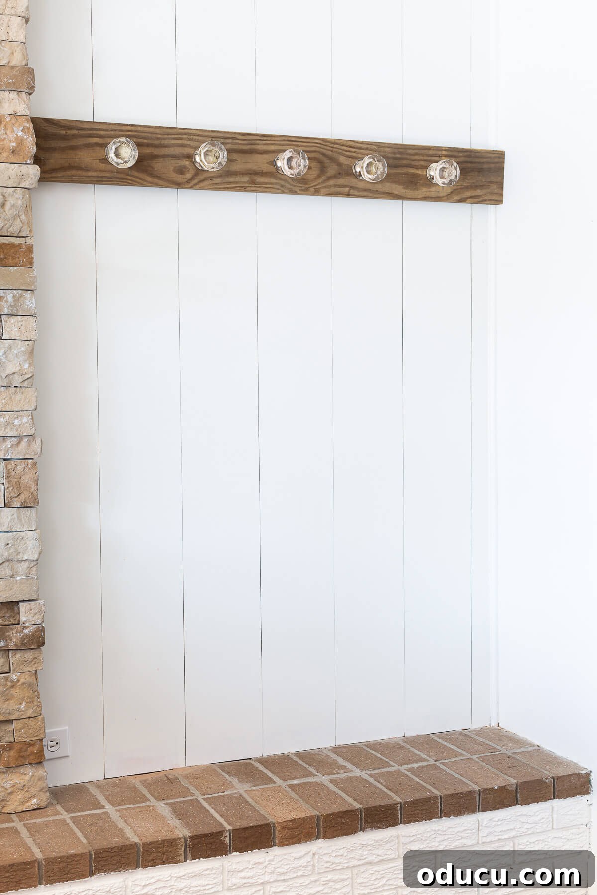 Blanket display idea made by mounting a board on a wall and attaching glass door knobs to decoratively hang blankets and quilts.
