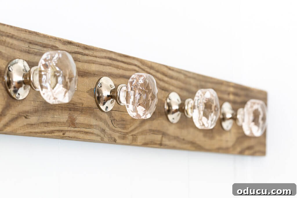 Elegant Wall Organizer for Living Room Throws 5 Wood board and glass doorknobs turned into a blanket holder for living room.