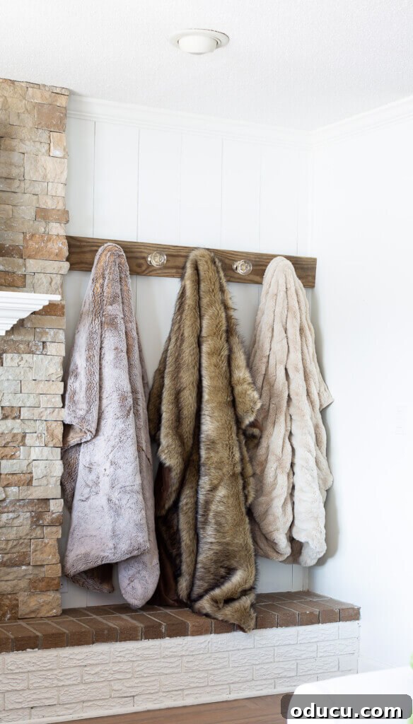 Elegant Wall Organizer for Living Room Throws 7 Blanket display ideas. 3 fur throws hung on a wall mounted throw blanket rack.
