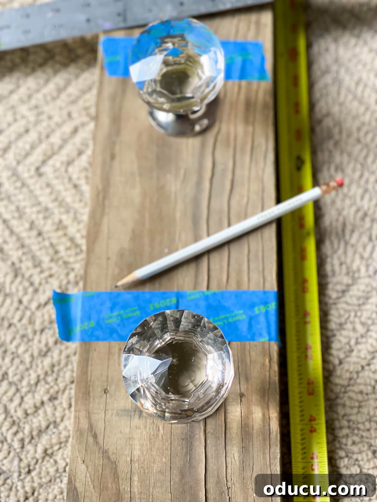 How to center doorknobs for blanket rack on wood board.