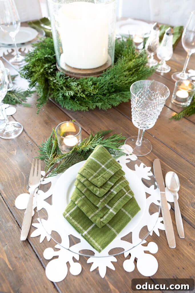 Festive Without the Fuss: Our Christmas Home Tour 20 An elegant holiday table setting featuring snowflake placemats and clear glass plates, creating a frosty, festive ambiance.