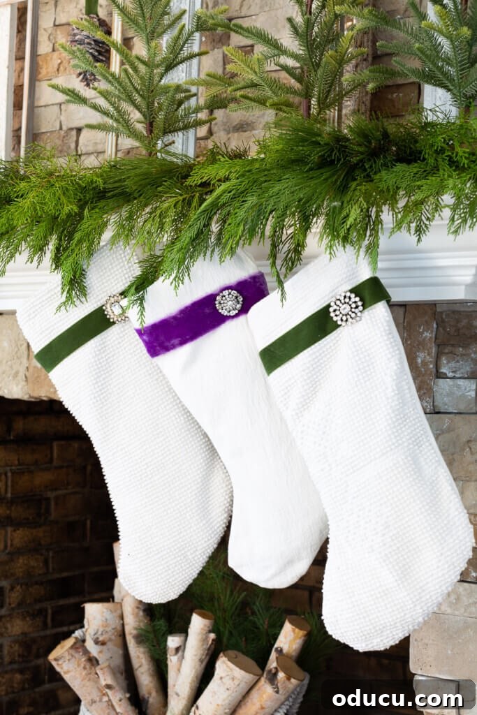 Festive Without the Fuss: Our Christmas Home Tour 5 Three pristine white Christmas stockings hanging gracefully on the mantel, ready for Santa's visit.
