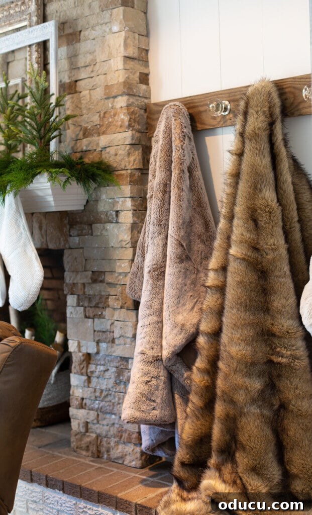 Festive Without the Fuss: Our Christmas Home Tour 6 A unique, handmade holder displaying cozy throw blankets on the living room wall, adding texture and warmth.
