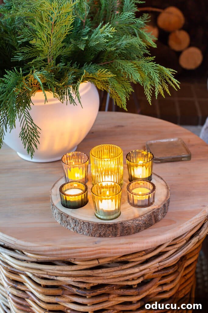 Festive Without the Fuss: Our Christmas Home Tour 10 A collection of Christmas candles arranged on a round wood wicker basket table, casting a warm, inviting glow.