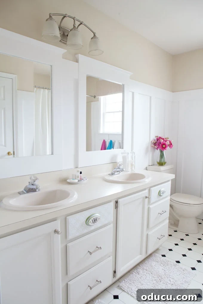 Transform Your Bathroom for $265 DIY Style 3 Beautifully framed bathroom mirrors complementing neutral colored walls with pops of decor.