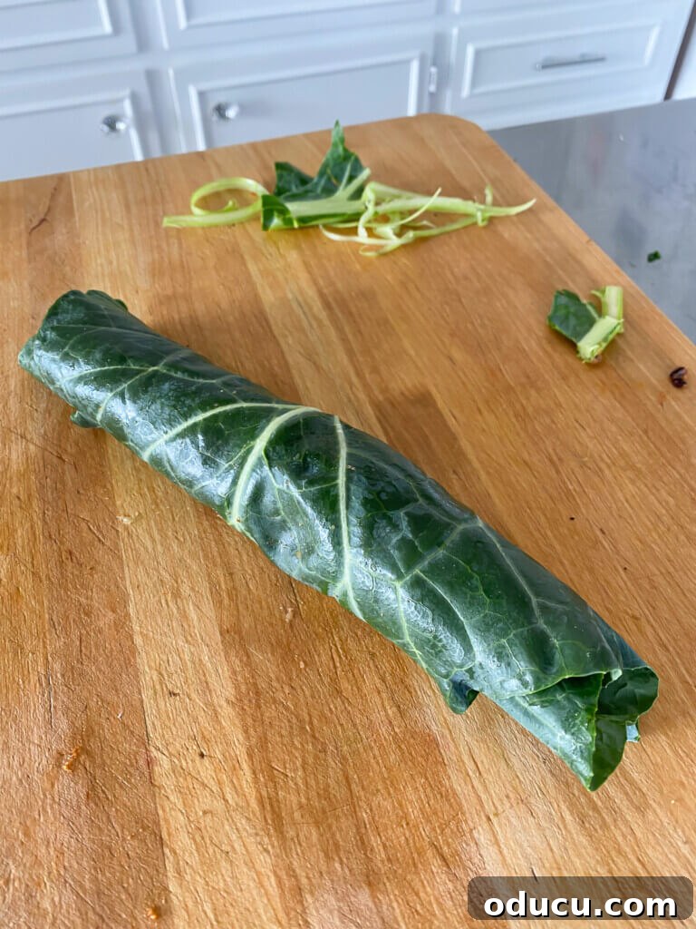 Effortless Vegan Collard Green Wraps 6 A collard green wrap on a cutting board