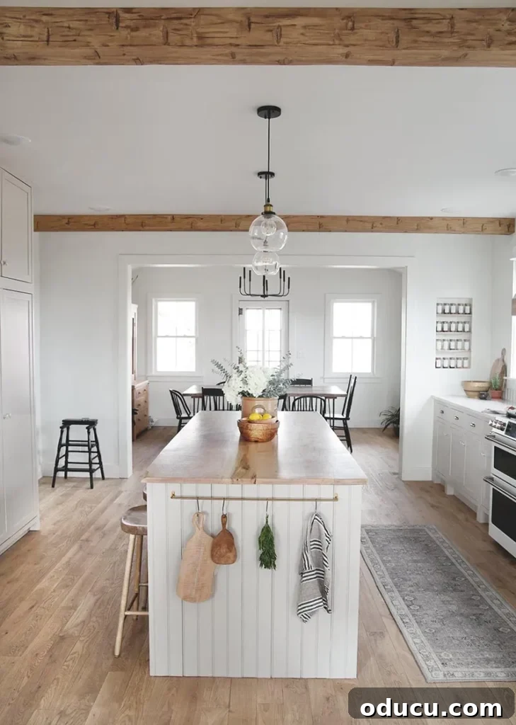 Fashion Finds 76 2 A stunning white kitchen makeover featuring rustic wooden beams and modern farmhouse elements, blending classic charm with contemporary design.