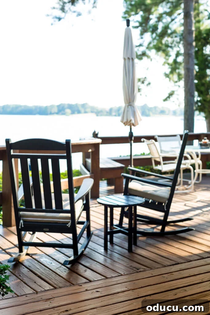 Beyond the View What Your Lake House Agent Isn't Telling You 6 Two black outdoor rockers on deck over looking a lake.