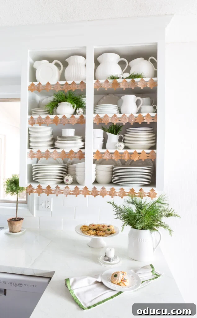 Open Kitchen Shelving: Cabinet Door Removal 23 Kitchen decorated for Christmas. Open shelfs trimmed with a cutout paper chain of pine tree shapes.