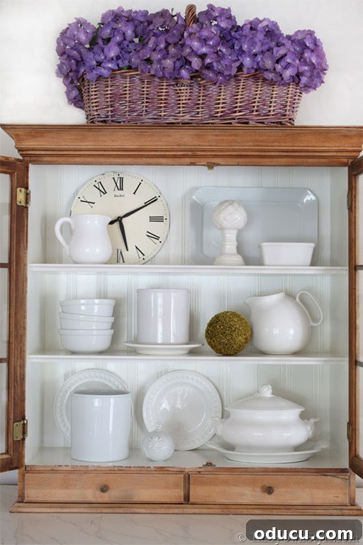 Open Kitchen Shelving: Cabinet Door Removal 25 Open kitchen cabinet styling idea using white dish ware, pitchers and decorative accessories.