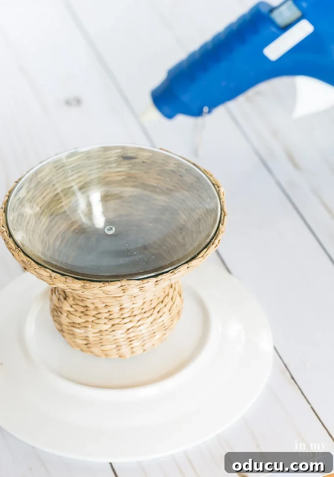 Unlock New Decor Ideas for Candle Holders 15 Applying glue to a wicker candle holder to attach it to a white plate, creating a bespoke pedestal.