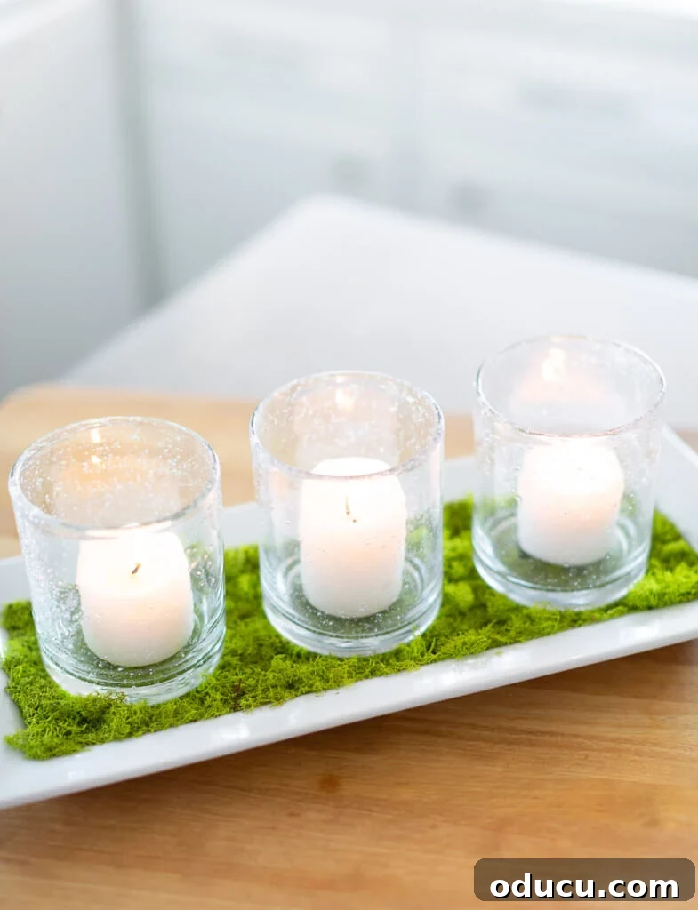 Unlock New Decor Ideas for Candle Holders 16 A charming three-votive candle table centerpiece, featuring natural moss for a modern spring feel.