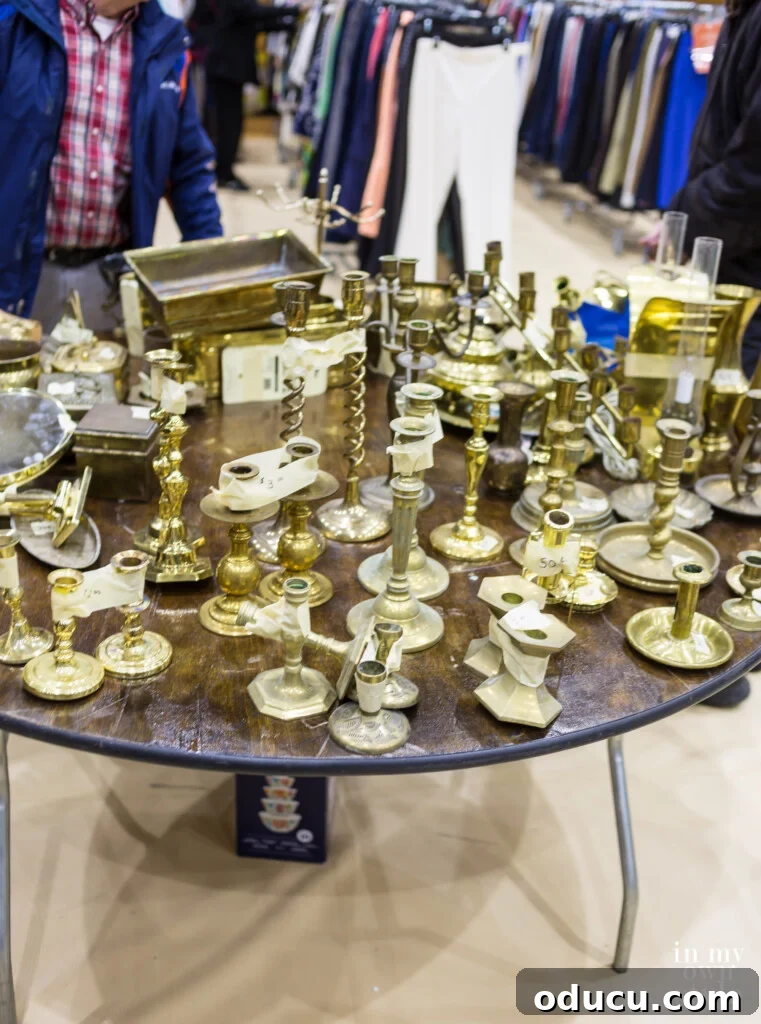 Unlock New Decor Ideas for Candle Holders 3 A charming display of brass candlesticks on a sales table at a holiday bazaar, showcasing their timeless appeal.