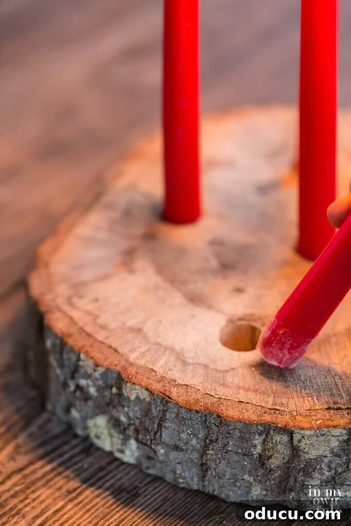 Unlock New Decor Ideas for Candle Holders 22 A step-by-step guide on how to place a taper candle in a drilled hole to create a tree trunk candle holder.