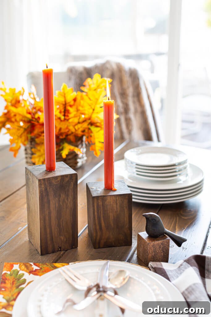 Unlock New Decor Ideas for Candle Holders 24 Completed DIY Wooden Candle Holders with dark orange taper candles on a dining table, showcasing modern design.
