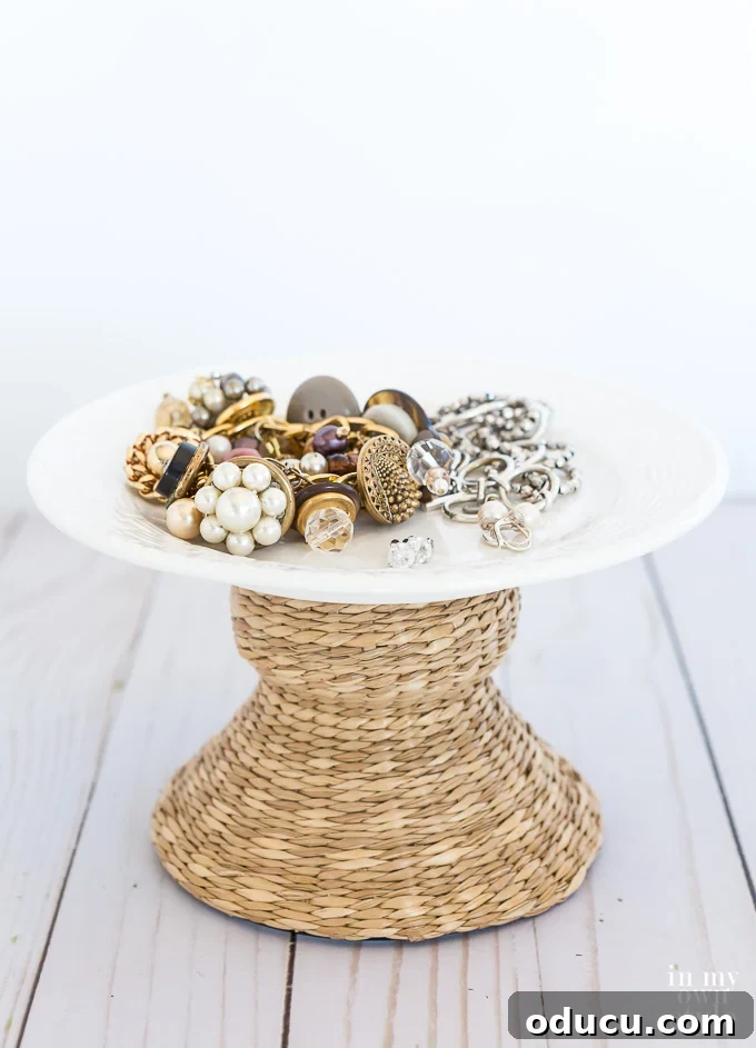 Unlock New Decor Ideas for Candle Holders 6 Elegant jewelry displayed on a plate, elevated by a wicker candle holder acting as a decorative pedestal.