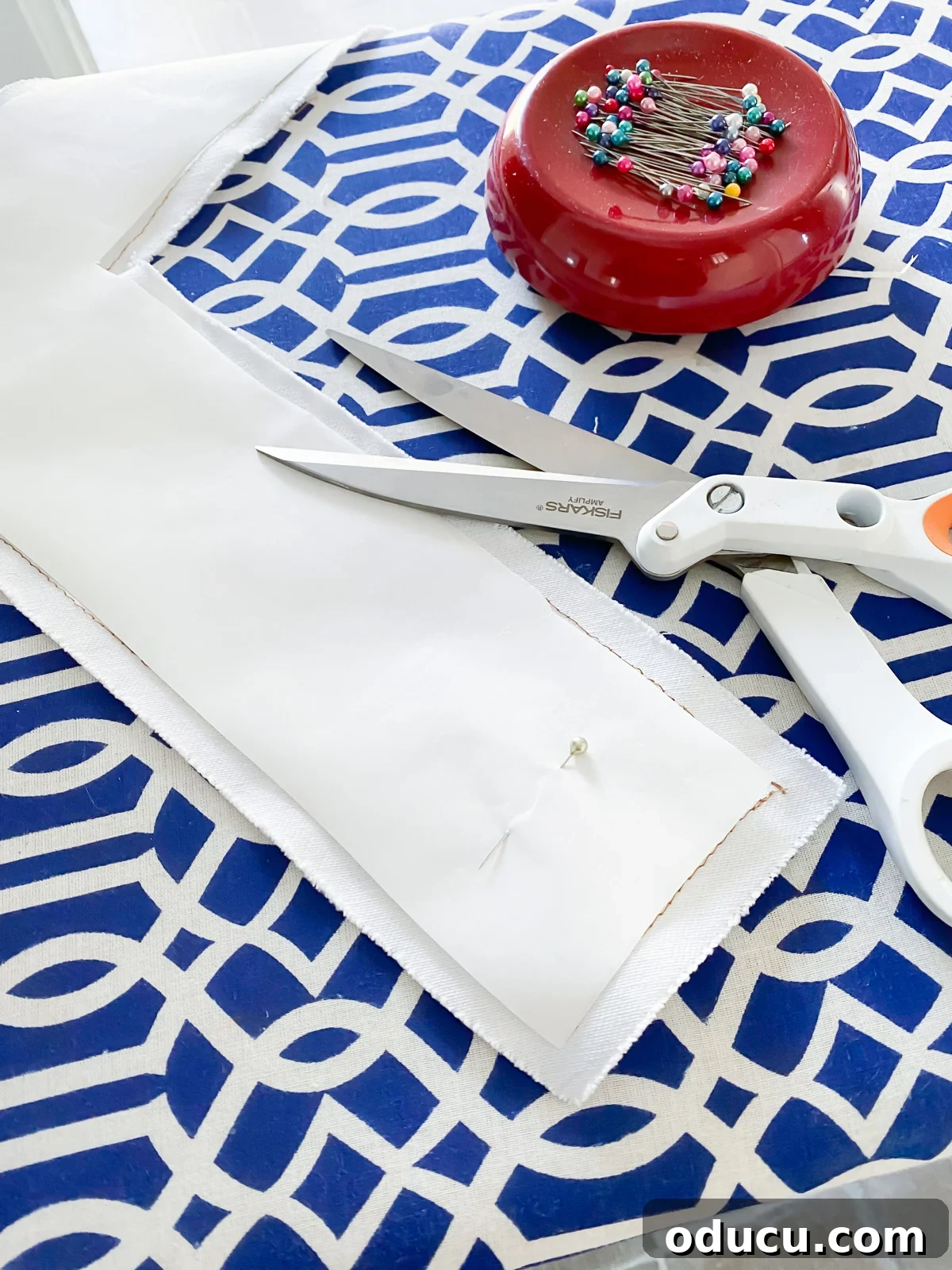 The process of attaching fusible web to the back of fabric, preparing it for applique onto a pillow.