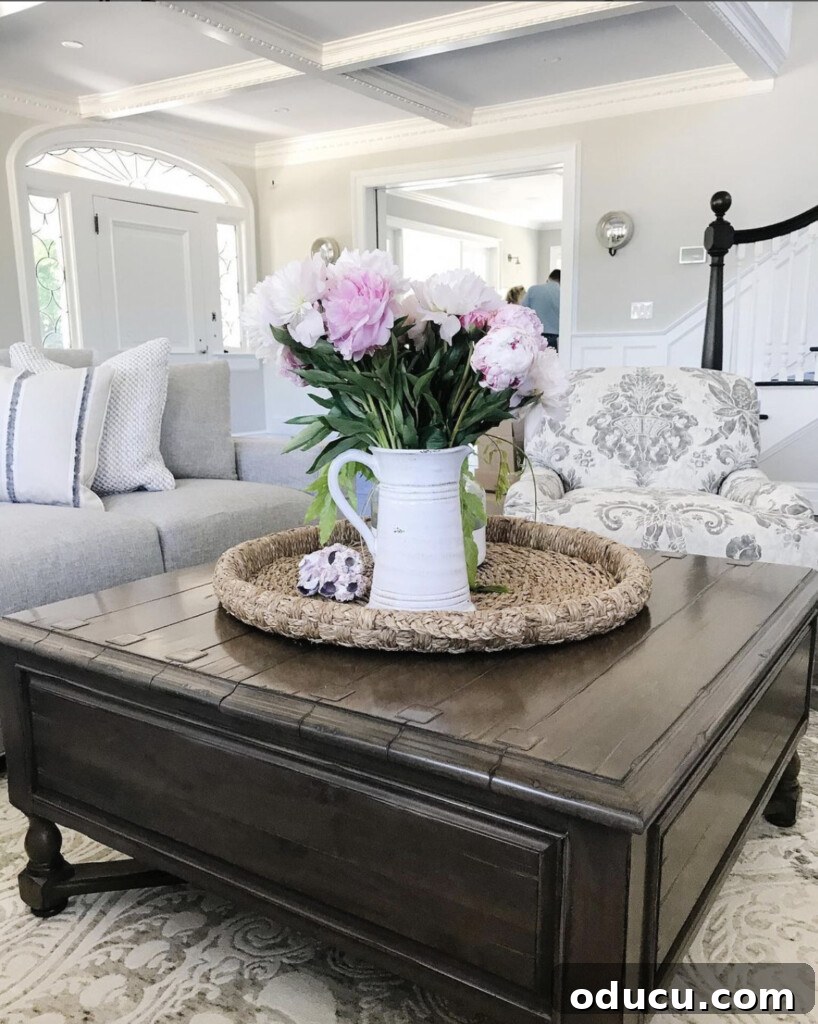 Fashion Finds Eighty 2 Square dark stained coffee table with a vase of peonies, styled in a living room with elegant, clean lines.