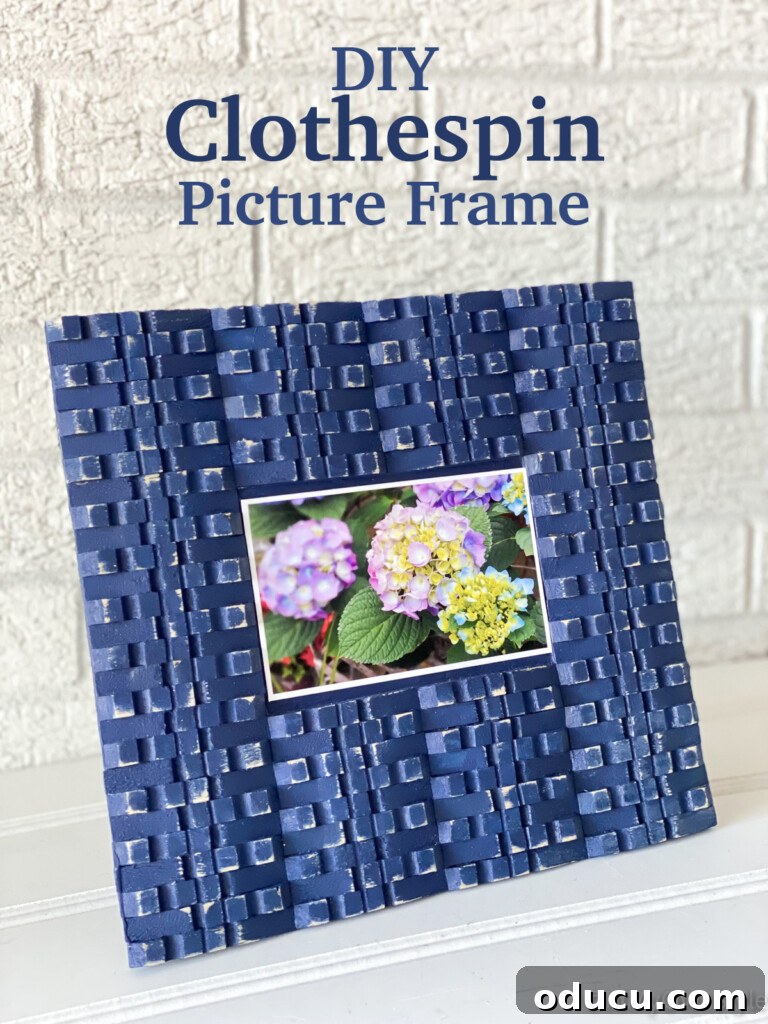 Craft Your Own Clothespin Display 13 blue painted clothespins made into a photo frame.