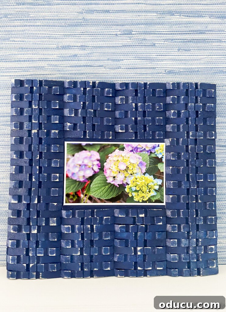 Craft Your Own Clothespin Display 5 DIY picture frame with clothespins leaning on a ledge.