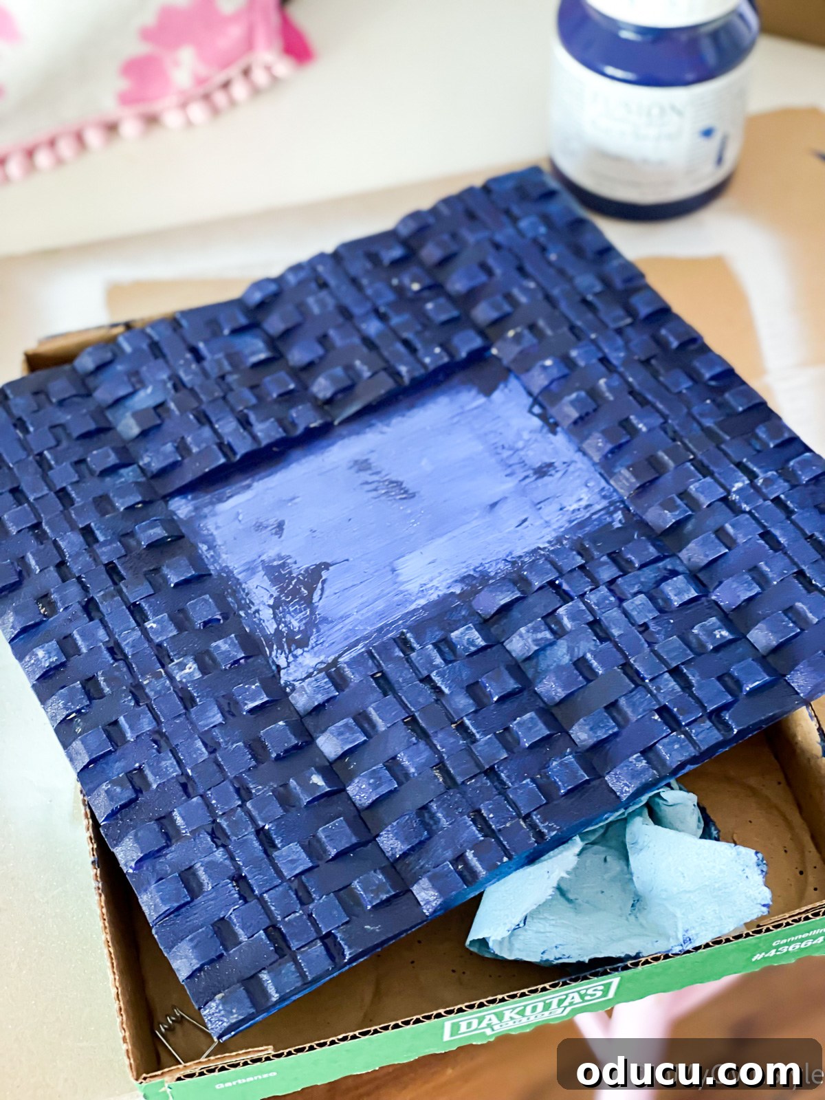 clothespin frame being painted blue