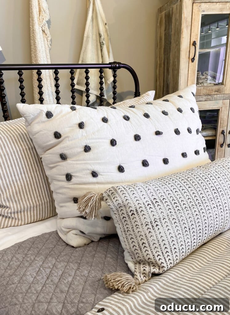 10 Easy DIY Decor Projects to Achieve a Designer Look for Less 5 Bed Pillow sham with small pom-poms on a bed