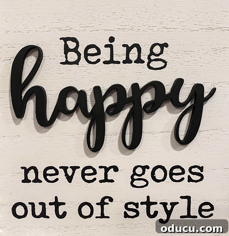 Style Discoveries 86 3 Being happy never goes out of style - A cheerful quote on a rustic sign, inspiring positivity and lasting joy in life.
