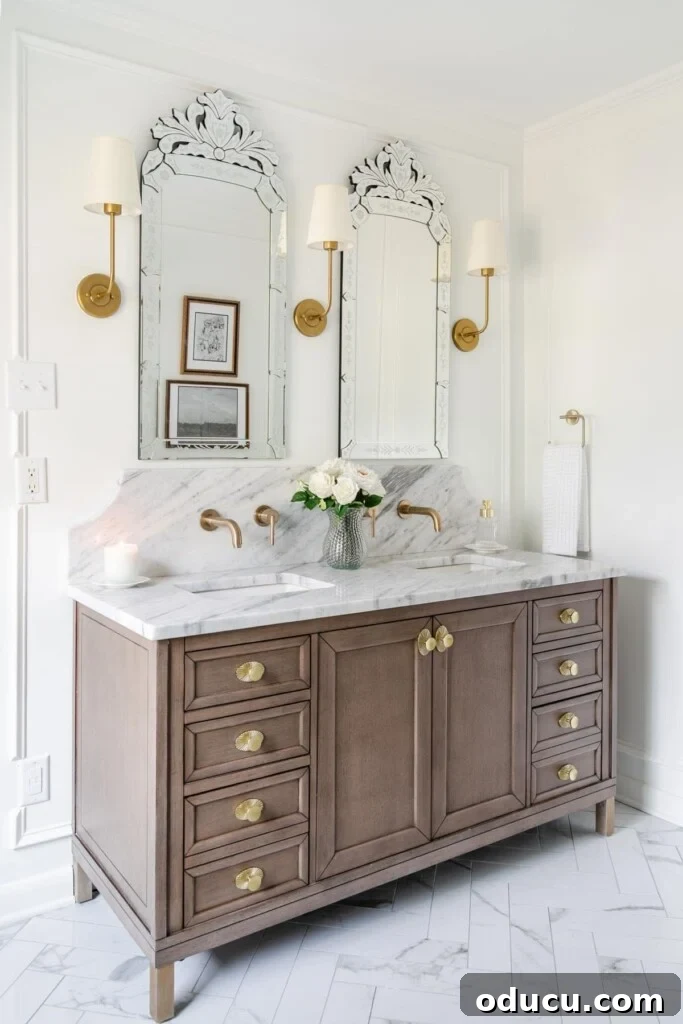 Eighty Seven Styles Uncovered 2 Master bathroom makeover after photo showcasing marble countertops and elegant brass accents.
