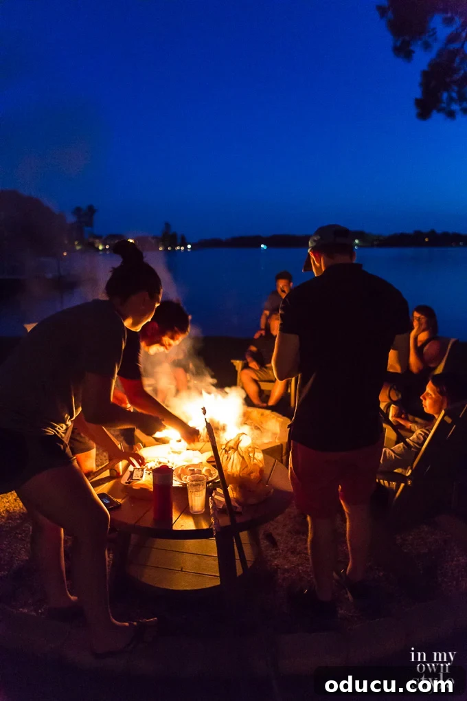 Build Your Own Tabletop Fire Pit in Minutes 2 People Standing around an outdoor fire roasting marshmallows