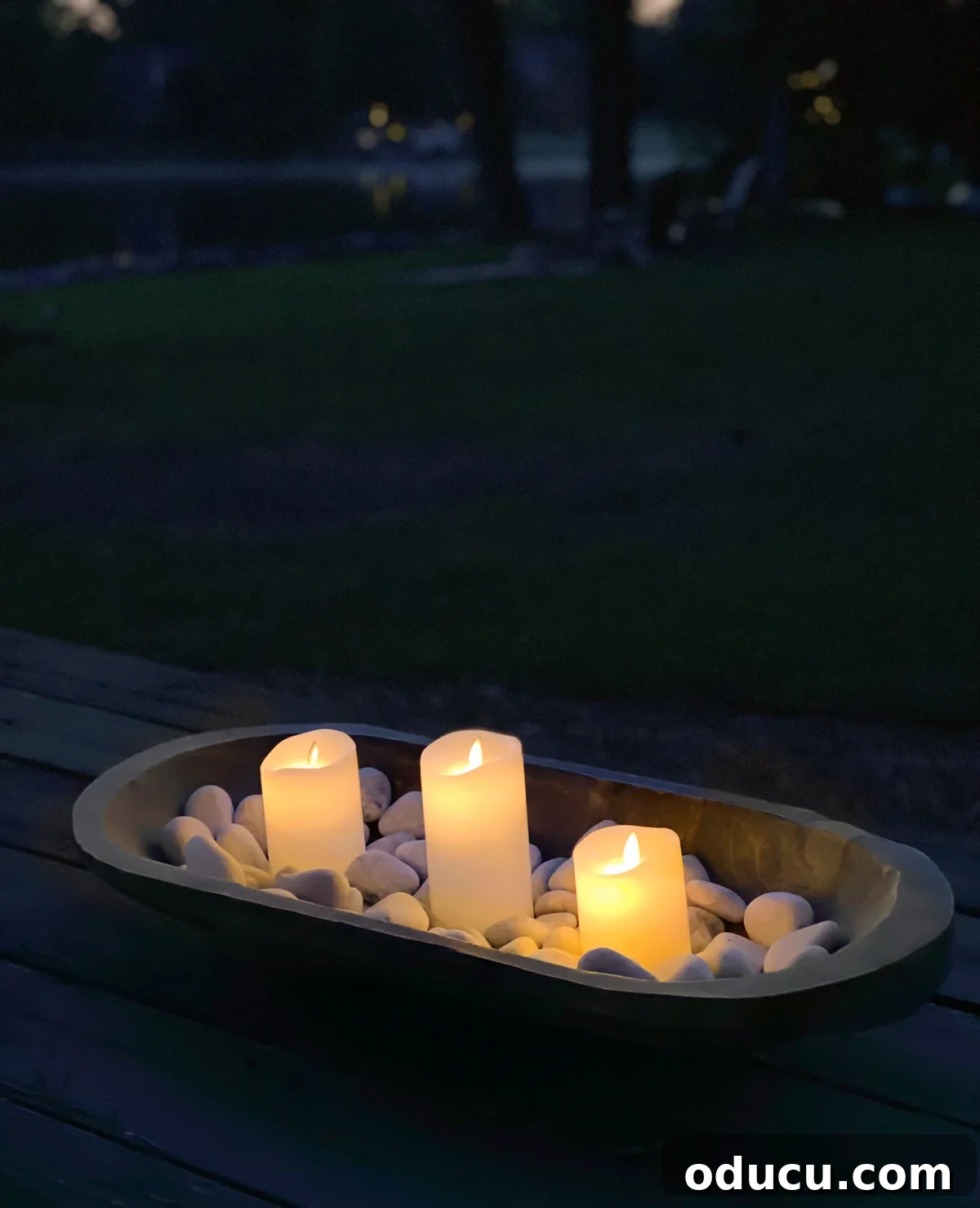 dough bowl filled with rocks and battery operated candles makes an instant tabletop fire bowl.