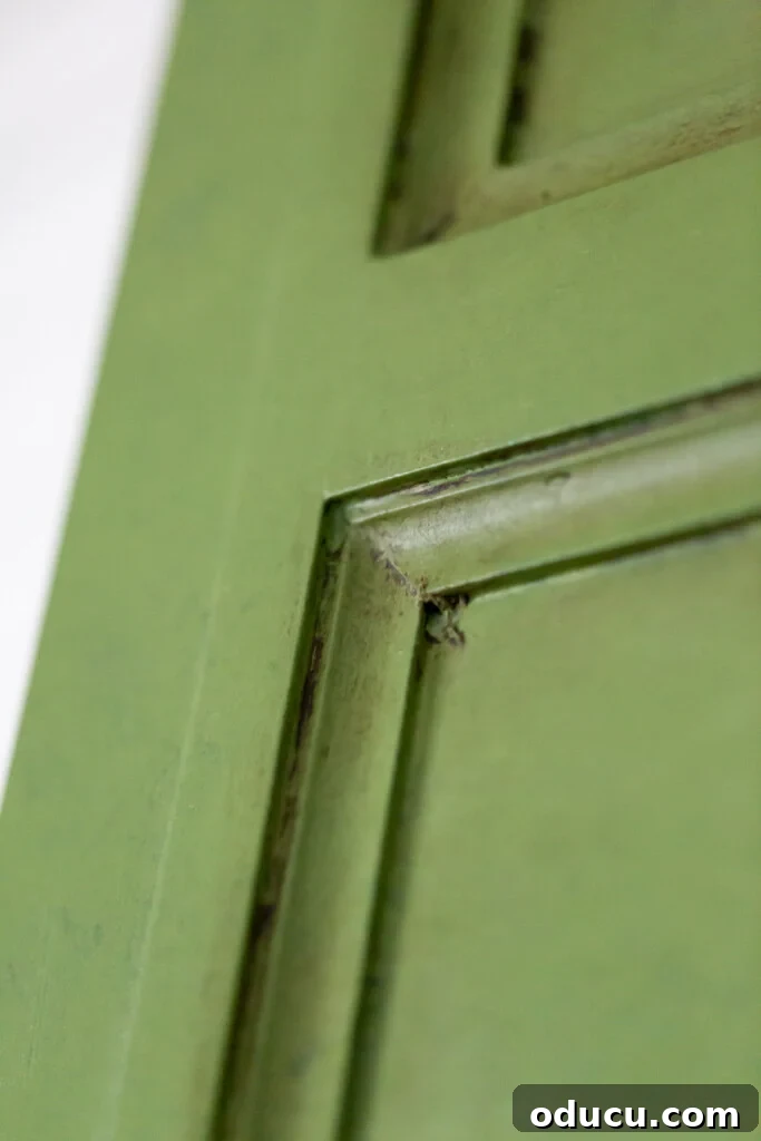 Effortless Glaze Finishes for Furniture 4 close up of a decorative paneled painted with green paint and glaze. Sealed with Annie Sloan dark wax.