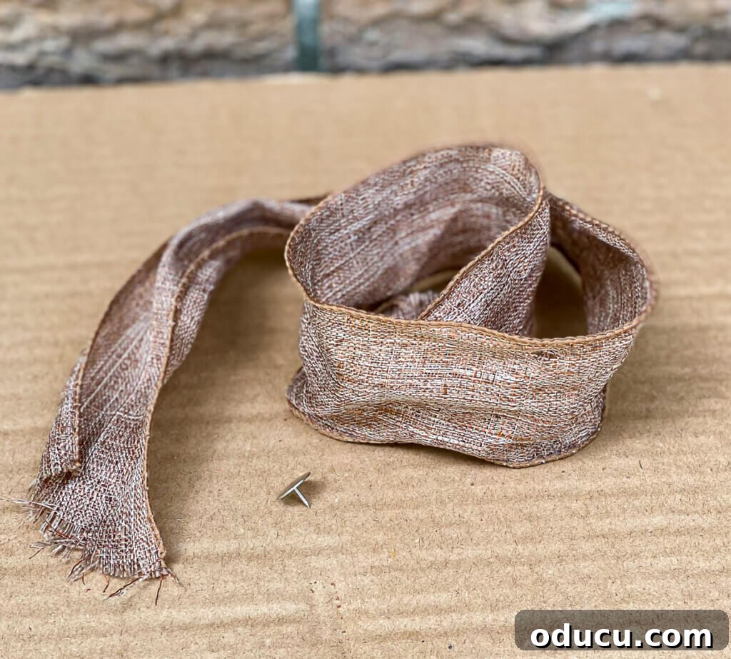 Cozy Fall Wicker Door Basket Project 11 ribbon and a thumb tack used to hang a flat basket on a door.