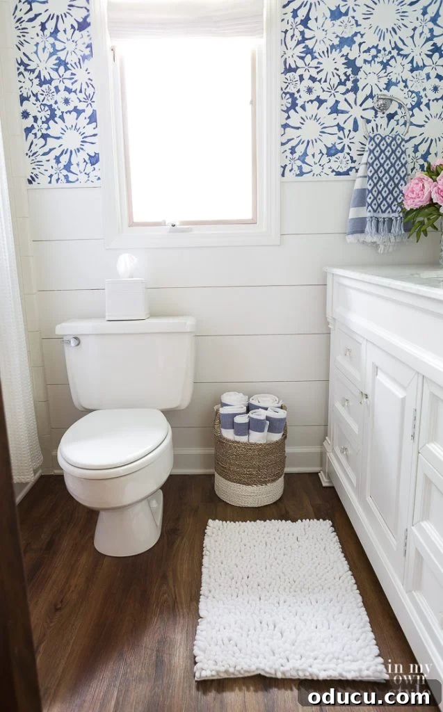 NuCore Flooring: The 6-Year Durability Verdict 6 NuCore vinyl plank flooring in Gunstock Oak installed over an old tile floor, contributing to a budget-friendly decor.