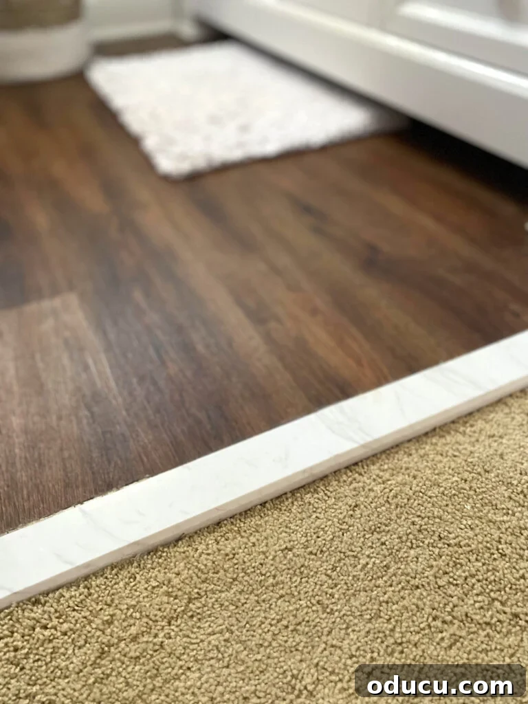 NuCore Flooring: The 6-Year Durability Verdict 8 A elegant marble threshold used as a transition between two different types and levels of flooring.
