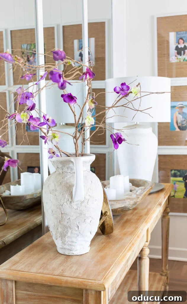 12 Affordable DIY Summer Decor Projects 2 A console table decorated for summer with light tones and subtle coastal accents.