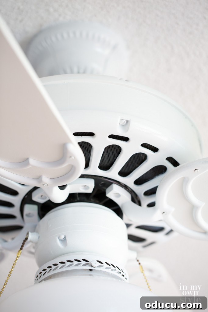 12 Affordable DIY Summer Decor Projects 11 A guide demonstrating how to paint a ceiling fan without the need for removal, illustrating a practical DIY tip.