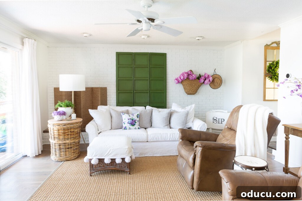 12 Affordable DIY Summer Decor Projects 4 A bright and airy living room showcasing summer decorating ideas, including rearranged furniture and light textiles.