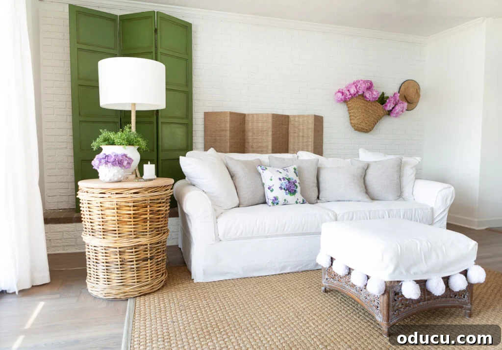 12 Affordable DIY Summer Decor Projects 7 A summer-decorated living room with a white fireplace screen cover, showcasing elegant and seasonal interior design.