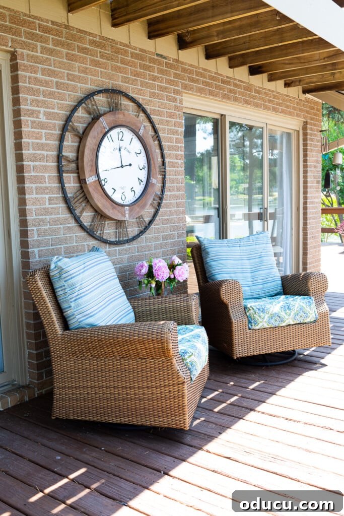 Make a Statement with Large Outdoor Clocks 12 outdoor wall clock hanging on brick wall on a deck.