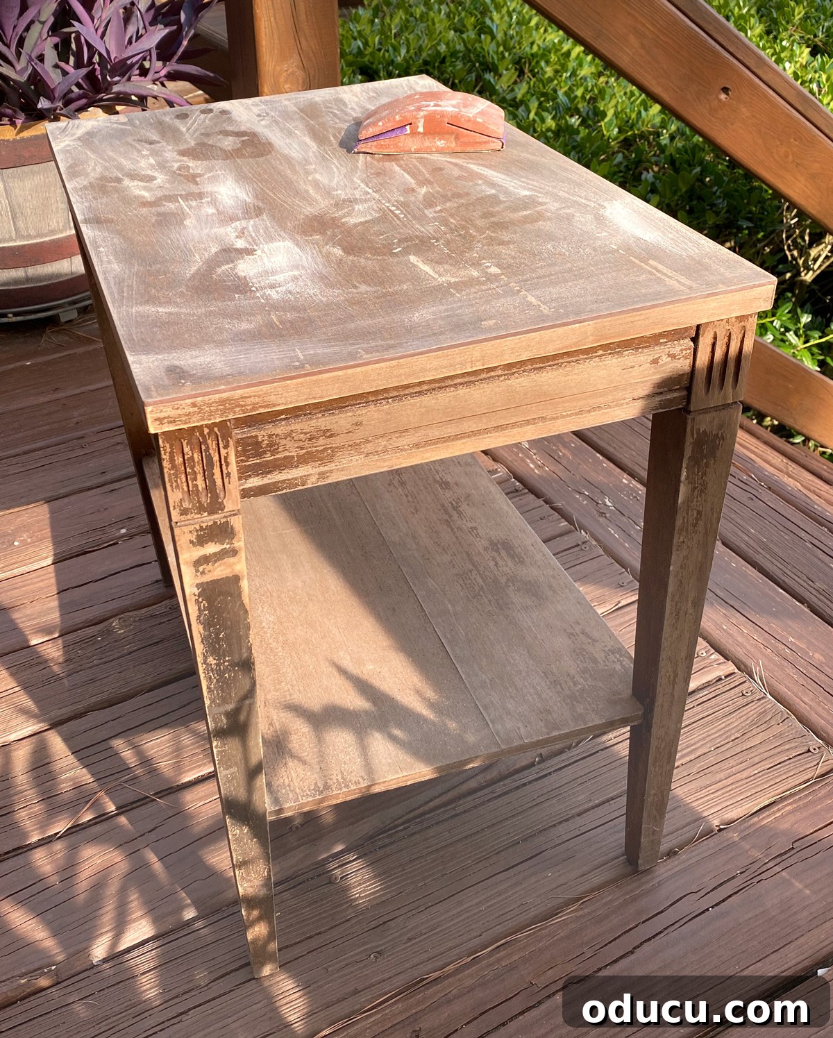 Designer Dupe Two-Tier End Table Makeover 15 Sanding a thrift store end table before painting to prepare the surface for a smooth finish.