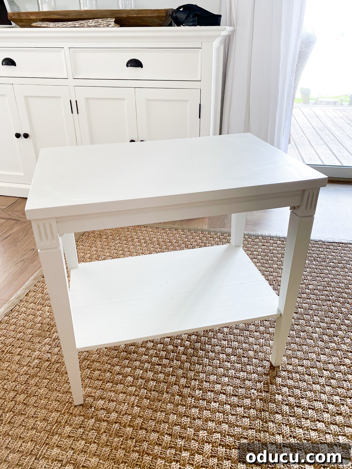 Designer Dupe Two-Tier End Table Makeover 16 A freshly painted white end table, showcasing a smooth and modern finish after the initial painting and sealing steps.