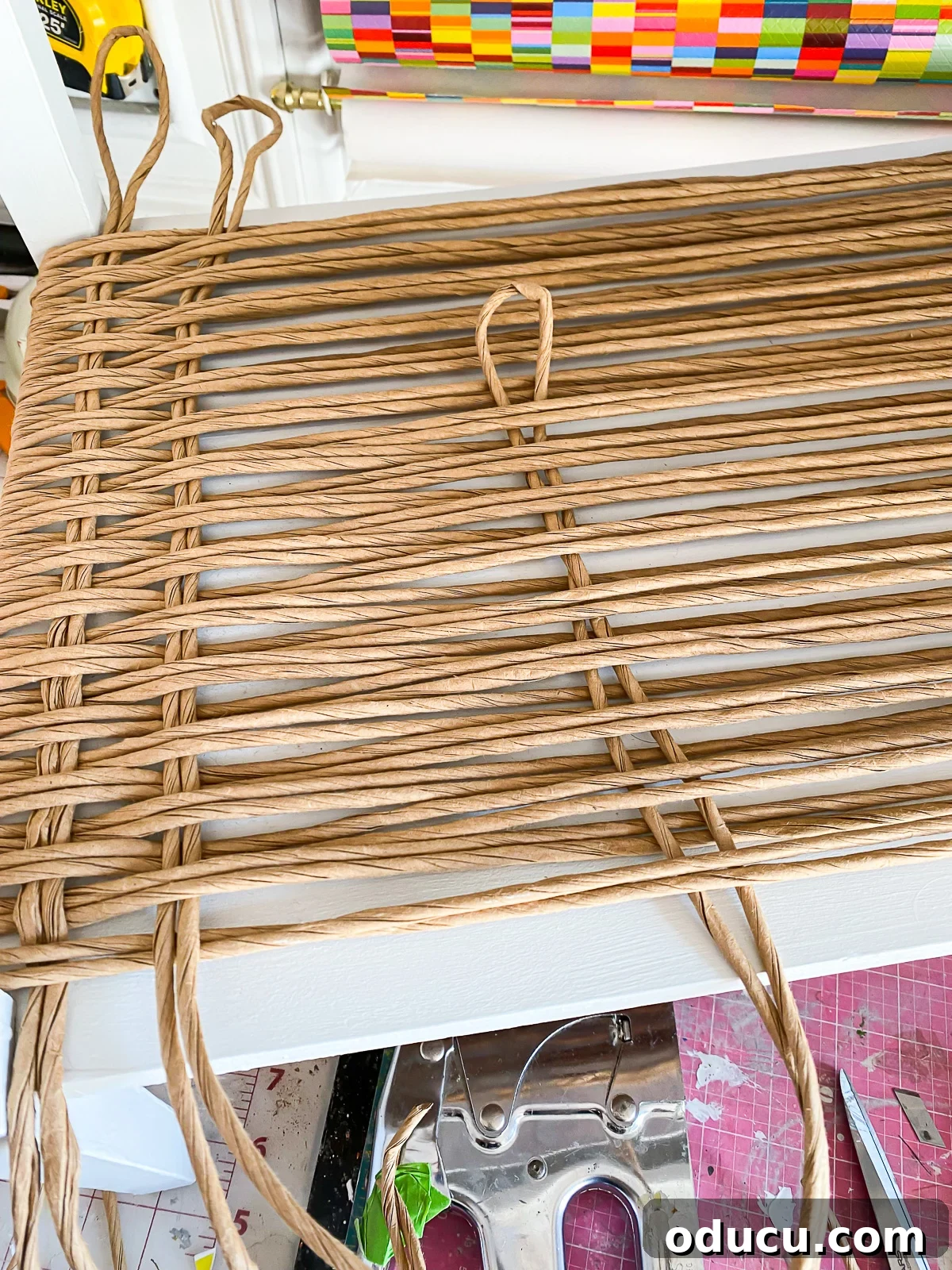 Designer Dupe Two-Tier End Table Makeover 21 Detailed instructions on how to weave fiber rushing to create an elegant woven effect on an end table, using a two-strand technique.