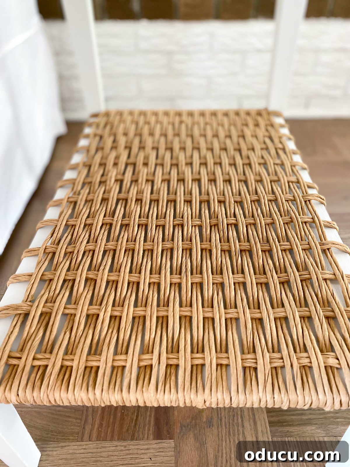 Designer Dupe Two-Tier End Table Makeover 26 A beautifully transformed side table featuring intricately woven fiber rush on its shelf and a crisp white chalk painted finish.