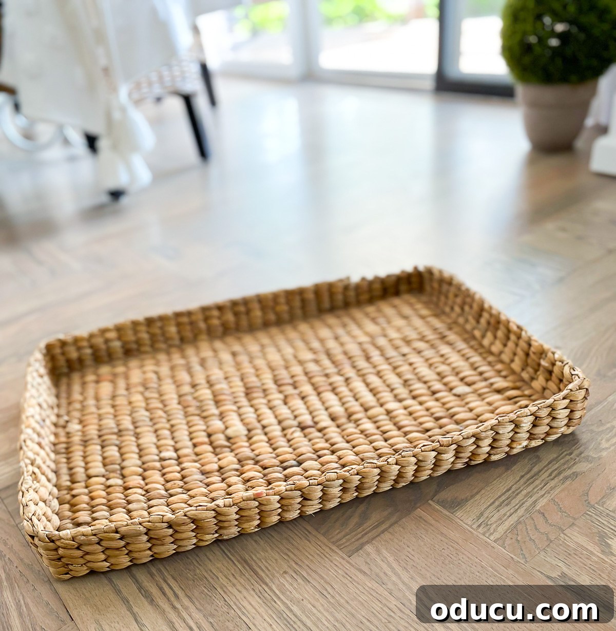 Designer Dupe Two-Tier End Table Makeover 27 A large, elegant woven tray from Pottery Barn, placed on the floor, ready to be added to the transformed end table's top.