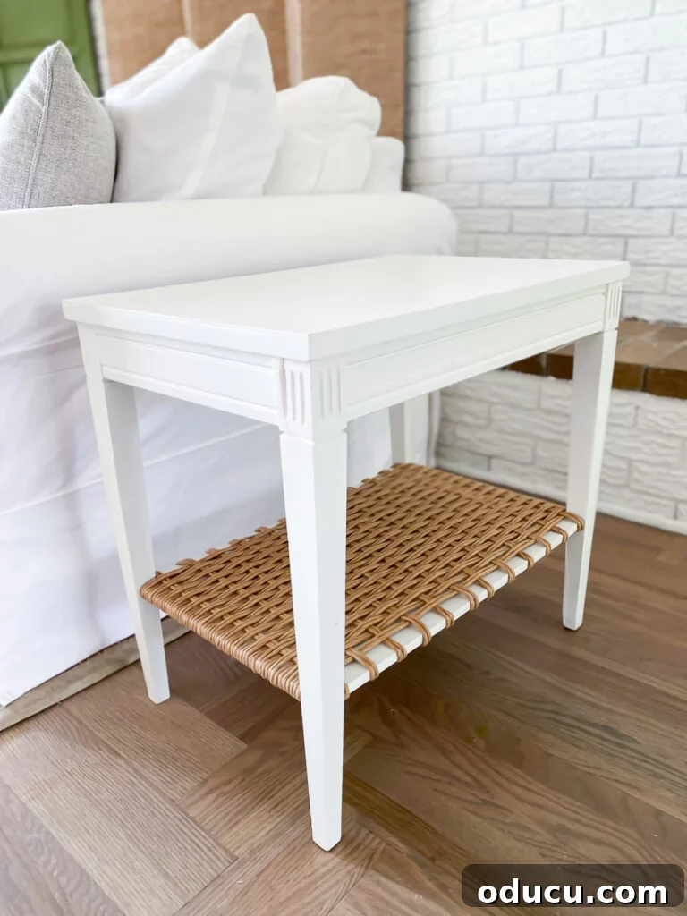Designer Dupe Two-Tier End Table Makeover 5 Close-up of the transformed thrift store table, showcasing the crisp white paint and the intricately woven paper fiber rush on the bottom shelf.