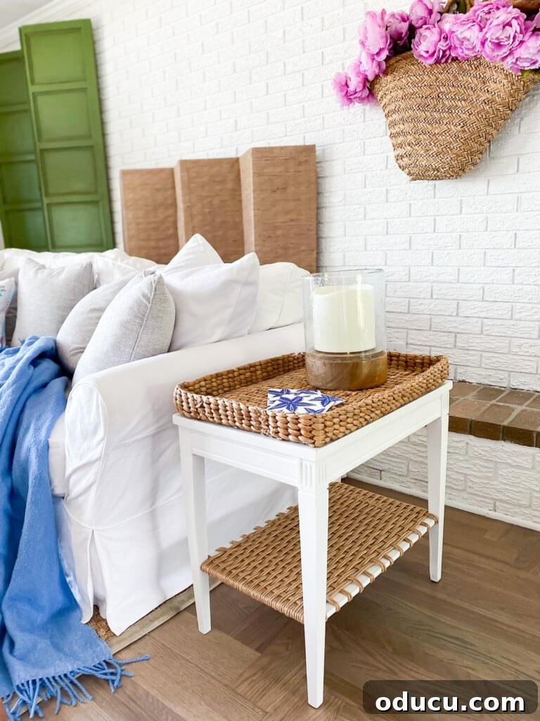 Designer Dupe Two-Tier End Table Makeover 6 Elegantly transformed end table positioned beside a sofa in a living room, complementing the coastal-inspired decor.
