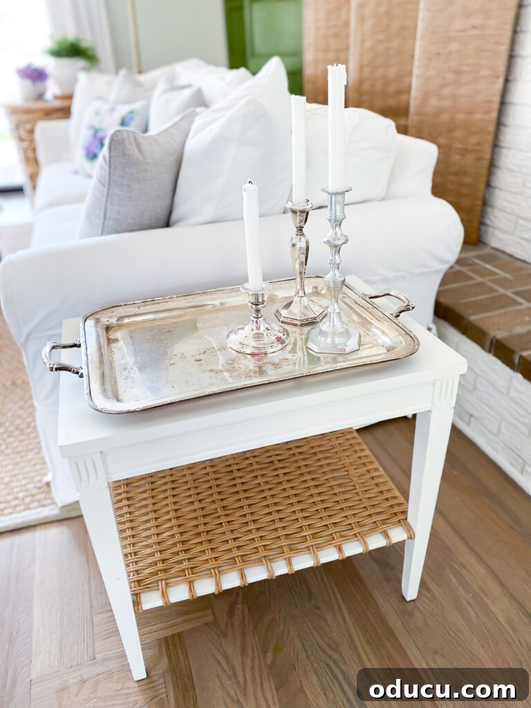 Designer Dupe Two-Tier End Table Makeover 9 Elegant silver tray with decorative candles arranged on top of the newly made-over wood end table, showcasing a sophisticated styling option.
