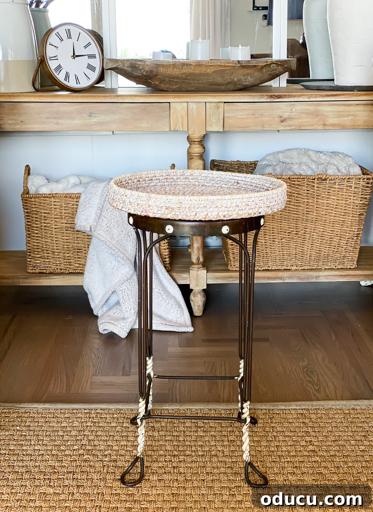 Reinvent Your Bar Stool as a Chic Accent Table 14 DIY side table made using a vintage metal stool and a round wicker tray, showcasing the completed project.
