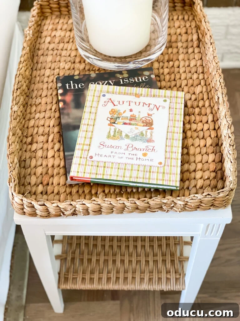 Embracing Autumn Hues in Your Living Space 11 Wicker tray table featuring two Autumn-themed books, inviting a cozy reading experience in a fall-decorated living room.